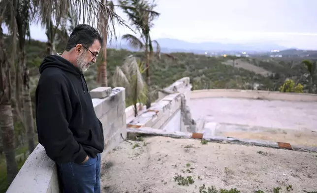 Hatim Naim stands in the ruins of his property which burned in the Mountain Fire Wednesday, April 16, 2025, in Somis, Calif. (AP Photo/Wally Skalij)