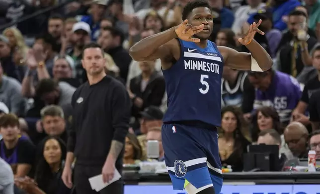 Minnesota Timberwolves guard Anthony Edwards (5) gestures after making a 3-point basket during the first half of Game 3 of an NBA basketball first-round playoff series against the Los Angeles Lakers, Friday, April 25, 2025, in Minneapolis. (AP Photo/Abbie Parr)