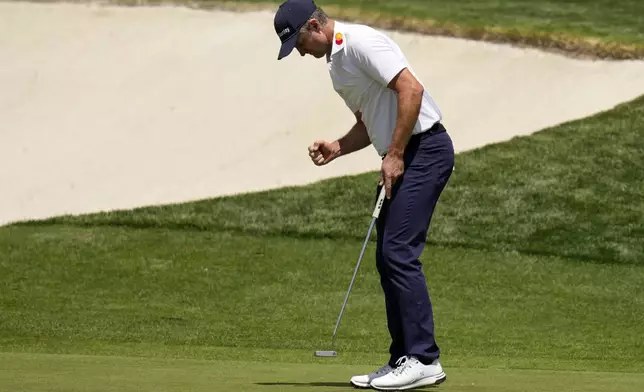 Justin Rose celebrates on the 17th hole during the second round at the Masters golf tournament, Friday, April 11, 2025, in Augusta, Ga. (AP Photo/David J. Phillip)