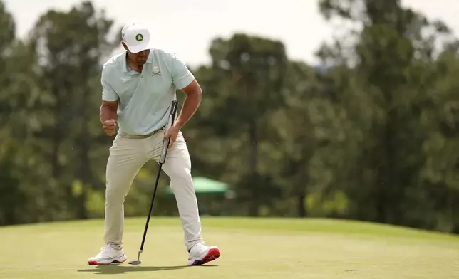 Bryson DeChambeau celebrates after making a putt on the 18th hole during the second round at the Masters golf tournament, Friday, April 11, 2025, in Augusta, Ga. (AP Photo/George Walker IV)