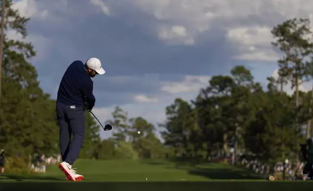 Scottie Scheffler hits his tee shot on the 14th hole during the second round at the Masters golf tournament, Friday, April 11, 2025, in Augusta, Ga. (AP Photo/David J. Phillip)