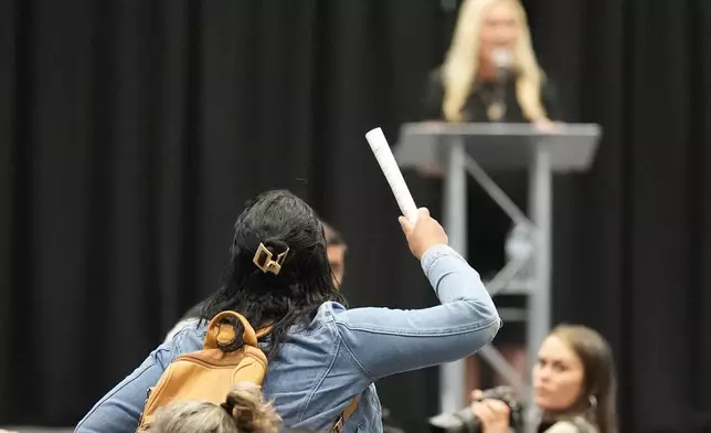 A protester is removed as Rep. Marjorie Taylor Greene, R-Ga., speaks during a town-hall style meeting, Tuesday, April 15, 2025, in Acworth, Ga. (AP Photo/Mike Stewart)