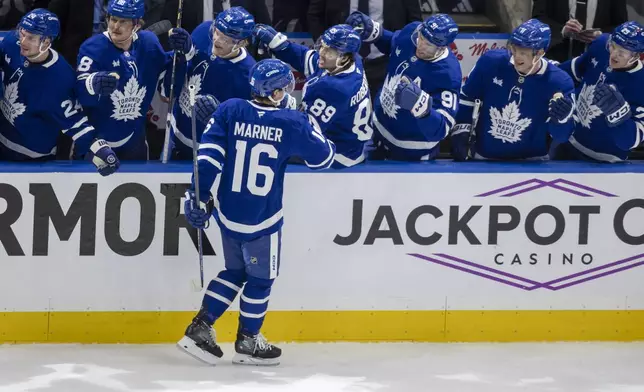 Toronto Maple Leafs' Mitch Marner (16) celebrates a goal against the Ottawa Senators during the first period of an NHL hockey playoff game in Toronto, Sunday, April 20, 2025. (Nick Iwanyshyn/The Canadian Press via AP)