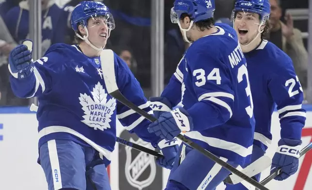 Toronto Maple Leafs' Mitch Marner (16), Auston Matthews (34) and Matthew Knies (23) celebrate a goal against the Ottawa Senators during first period NHL playoff action in Toronto, on Sunday, April 20, 2025. (Frank Gunn/The Canadian Press via AP)