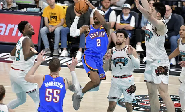 Oklahoma City Thunder guard Shai Gilgeous-Alexander (2) looks to pass between Memphis Grizzlies forward Jaren Jackson Jr. (13), guard Scotty Pippen Jr. (1), and center Zach Edey (14) in the second half of Game 3 of an NBA first-round playoff series Thursday, April 24, 2025, in Memphis, Tenn. (AP Photo/Brandon Dill)