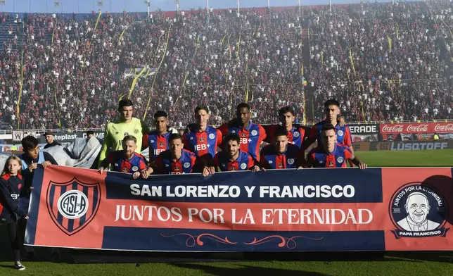San Lorenzo players pose for a team photo wearing club jerseys commemorating the late Pope Francis who was a lifelong supporter of the club, during a local soccer match against Rosario Central in Buenos Aires, Argentina, Saturday, April 26, 2025. (AP Photo/Gustavo Garello)