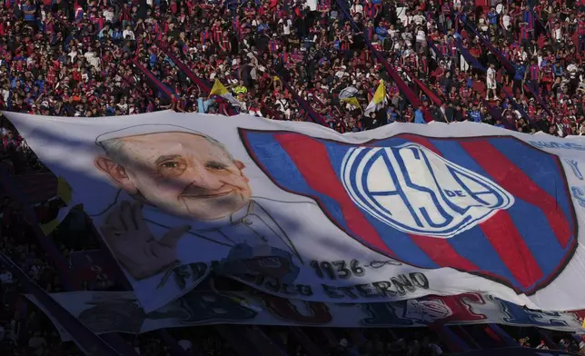 A San Lorenzo banner featuring the late Pope Francis is displayed in the stands, commemorating Francis who was a lifelong supporter of the club, during a local soccer match against Rosario Central in Buenos Aires, Argentina, Saturday, April 26, 2025. (AP Photo/Gustavo Garello)