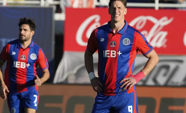 San Lorenzo's Andres Vombergar, right, wears a club jersey commemorating the late Pope Francis who was a lifelong supporter of the club, during a local soccer match against Rosario Central in Buenos Aires, Argentina, Saturday, April 26, 2025. (AP Photo/Gustavo Garello)