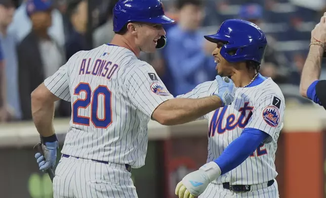 New York Mets' Pete Alonso, left, celebrates with Francisco Lindor after Lindor hit a two-run home run during the second inning of a baseball game against the Arizona Diamondbacks Tuesday, April 29, 2025, in New York. (AP Photo/Frank Franklin II)
