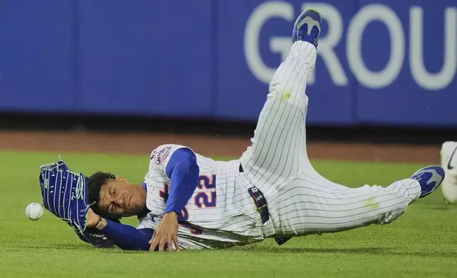 New York Mets' Juan Soto dives for a ball hit by Arizona Diamondbacks' Jorge Barrosa for an RBI double during the fifth inning of a baseball game Tuesday, April 29, 2025, in New York. (AP Photo/Frank Franklin II)