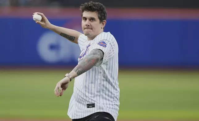 John Mayer throws out a ceremonial first pitch before a baseball game between the New York Mets and the Arizona Diamondbacks Tuesday, April 29, 2025, in New York. (AP Photo/Frank Franklin II)