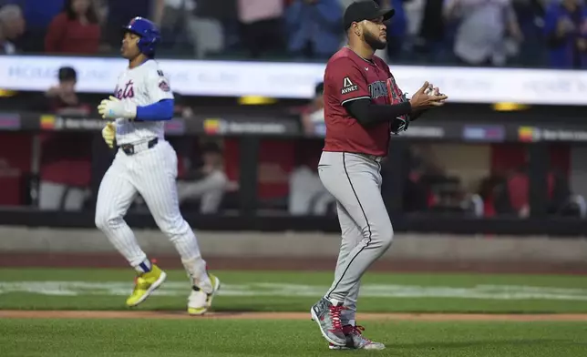 Arizona Diamondbacks pitcher Eduardo Rodriguez, right, reacts as New York Mets' Francisco Lindor runs the bases after hitting a two-run home run during the second inning of a baseball game Tuesday, April 29, 2025, in New York. (AP Photo/Frank Franklin II)