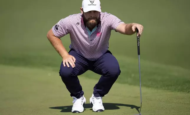 Tyrrell Hatton, of England, lines up a putt on the second hole during the first round at the Masters golf tournament, Thursday, April 10, 2025, in Augusta, Ga. (AP Photo/George Walker IV)