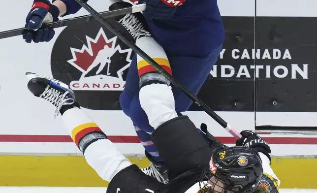 United States' Taylor Heise, back checks Germany's Laura Kluge during the quarterfinal match between United States and Germany at the Women's Ice Hockey Championships in Ceske Budejovice, Czech Republic, Thursday, April 17, 2025. (AP Photo/Petr David Josek)