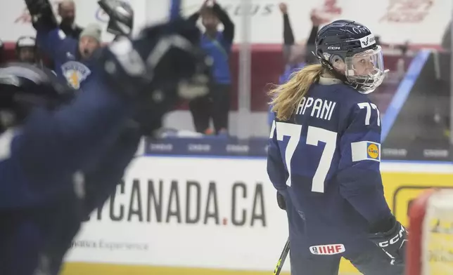 Finland's Susanna Tapani celebrates after scoring her sides third goal during the quarterfinal match between Finland and Sweden at the Women's Ice Hockey Championships in Ceske Budejovice, Czech Republic, Thursday, April 17, 2025. (AP Photo/Petr David Josek)