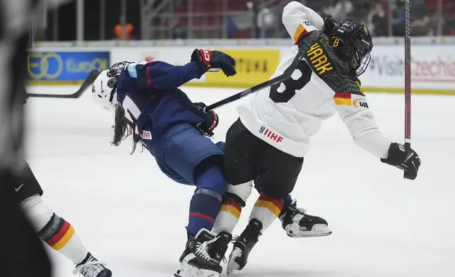 Germany's Ronja Hark, right, chatges United States' Abbey Murphy during the quarterfinal match between United States and Germany at the Women's Ice Hockey Championships in Ceske Budejovice, Czech Republic, Thursday, April 17, 2025. (AP Photo/Petr David Josek)