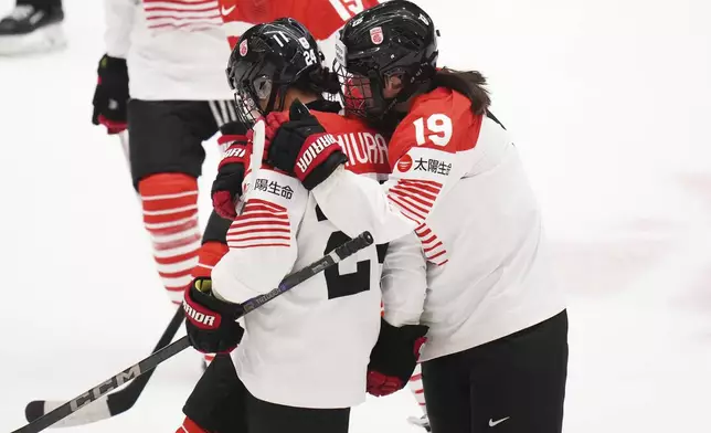 Japan's Mei Miura, left, celebrates with Japan's Makoto Ito after scoring her sides first goal during the quarterfinal match between Canada and Japan at the Women's Ice Hockey Championships in Ceske Budejovice, Czech Republic, Thursday, April 17, 2025. (AP Photo/Petr David Josek)