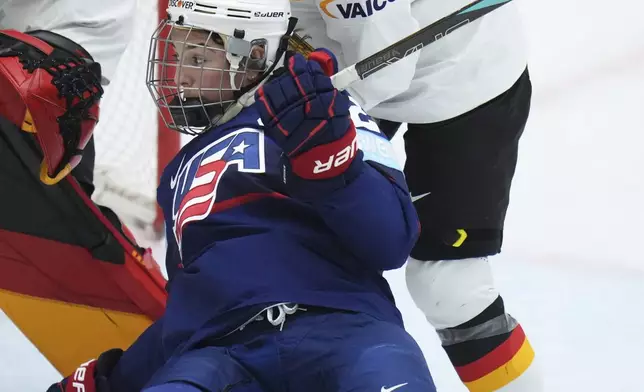 Germany's Carina Strobel, back, checks United States' Hilary Knight during the quarterfinal match between United States and Germany at the Women's Ice Hockey Championships in Ceske Budejovice, Czech Republic, Thursday, April 17, 2025. (AP Photo/Petr David Josek)