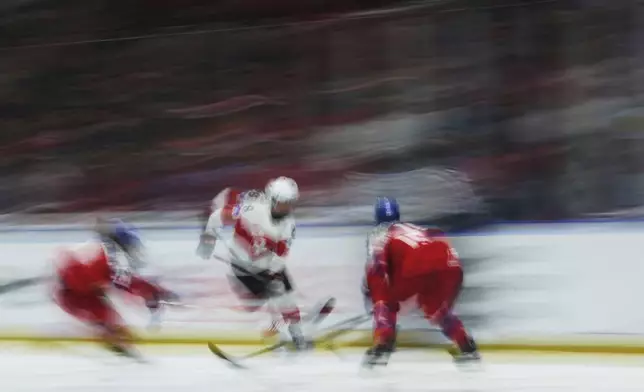 Kaleigh Quennec of Switzerland controls the puck during the quarterfinal match between Czech Republic and Switzerland at the Women's Ice Hockey Championships in Ceske Budejovice, Czech Republic, Thursday, April 17, 2025. (AP Photo/Petr David Josek)