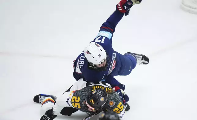 Germany's Laura Kluge, down, collides with United States' Britta Curl during the quarterfinal match between United States and Germany at the Women's Ice Hockey Championships in Ceske Budejovice, Czech Republic, Thursday, April 17, 2025. (AP Photo/Petr David Josek)