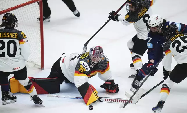 Germany's Sandra Abstreiter makes a save during the quarterfinal match between United States and Germany at the Women's Ice Hockey Championships in Ceske Budejovice, Czech Republic, Thursday, April 17, 2025. (AP Photo/Petr David Josek)