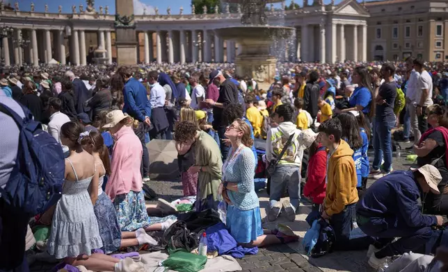 Faithful pray during the funeral of Pope Francis in St. Peter's Square at the Vatican, Saturday, April 26, 2025. (AP Photo/Emilio Morenatti)