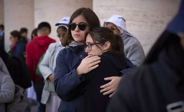 Faithful react during the funeral of Pope Francis in St. Peter's Square at the Vatican, Saturday, April 26, 2025. (AP Photo/Emilio Morenatti)