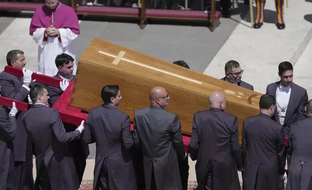 Pallbearers carry the coffin during the funeral of Pope Francis in St. Peter's Square at the Vatican, Saturday, April 26, 2025. (AP Photo/Markus Schreiber)