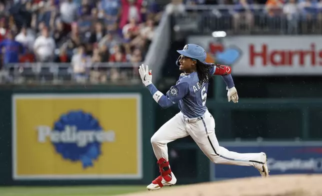 Washington Nationals' CJ Abrams runs the bases after hitting a triple off New York Mets pitcher Kodai Senga during the third inning of a baseball game in Washington, Friday, April 25, 2025. (AP Photo/Terrance Williams)
