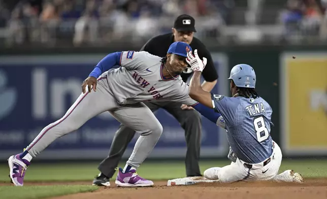 Washington Nationals' José Tena (8) is tagged out by New York Mets shortstop Francisco Lindor, front left, while attempting to steal second base during the second inning of a baseball game in Washington, Friday, April 25, 2025. (AP Photo/Terrance Williams)