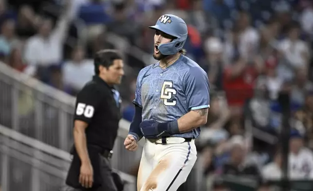 Washington Nationals' Dylan Crews celebrates after scoring a run on a single hit by José Tena off New York Mets pitcher Kodai Senga during the second inning of a baseball game in Washington, Friday, April 25, 2025. (AP Photo/Terrance Williams)