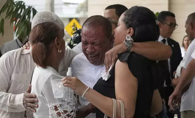 Family members mourn during the memorial of Octavio Dotel, a former MLB baseball player who died at the Jet Set nightclub where more than 200 people were killed when its roof collapsed, in Santo Domingo, Dominican Republic, Thursday, April 10, 2025. (AP Photo/Matias Delacroix)