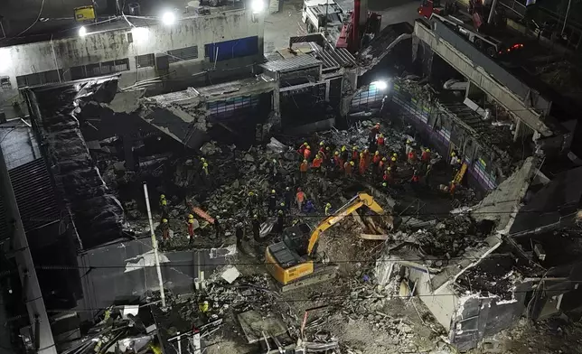 Rescue workers search for bodies at the Jet Set nightclub after its roof collapsed during a merengue concert in Santo Domingo, Dominican Republic, Thursday, April 10, 2025. (AP Photo/Matias Delacroix)
