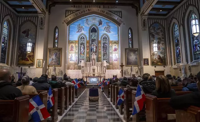 People attend a Mass for the victims of the Jet Set club roof collapse, at St. Elizabeth's Church, Wednesday, April 9, 2025 in New York. (AP Photo/Adam Gray)