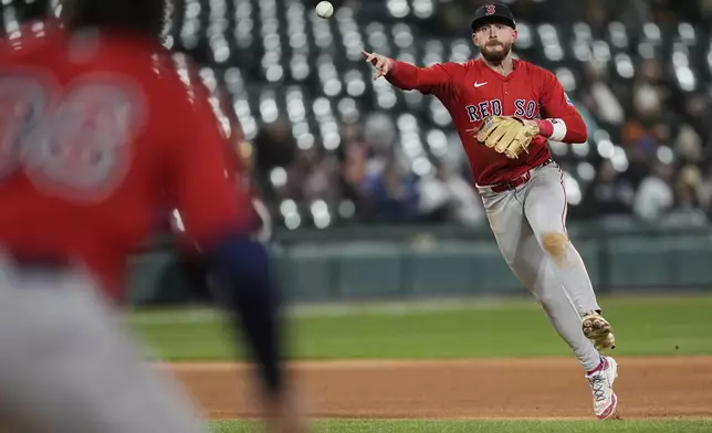 Boston Red Sox shortstop Trevor Story, right, throws out Chicago White Sox's Lenyn Sosa (not shown) during the sixth inning of a baseball game Friday, April 11, 2025, in Chicago. (AP Photo/Erin Hooley)