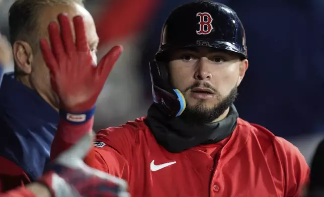 Boston Red Sox's Wilyer Abreu celebrates after scoring on a sacrifice fly by Blake Sabol during the seventh inning of a baseball game against the Chicago White Sox, Friday, April 11, 2025, in Chicago. (AP Photo/Erin Hooley)