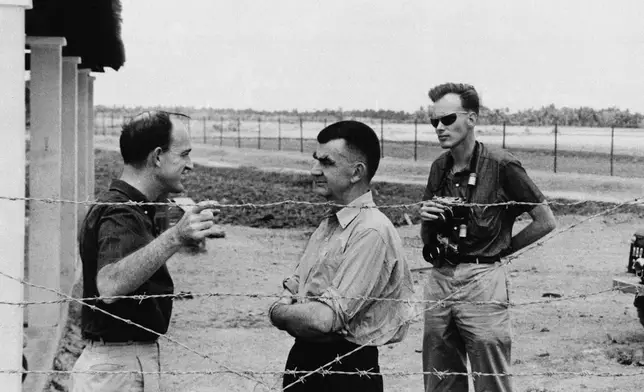 Wes Gallagher, center, general manager of the Associated Press, and Malcolm Browne, right, AP Saigon correspondent, speak with colleague Peter Arnett in Tan An, capital city of the Long An province in the Mekong Delta of Vietnam, March 23, 1964. (AP Photo)