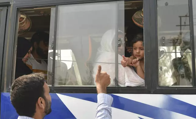 An Indian relative gives thumbs up to a Pakistani family as they leave in a bus at the Attari-Wagah border between India and Pakistan, near Amritsar, India, following New Delhi’s decision to order almost all Pakistani citizens to leave the country after last week’s deadly attack in Indian-controlled Kashmir, Wednesday, April 30, 2025. (AP Photo/Prabhjot Gill)