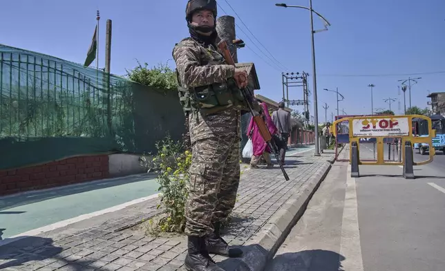 An Indian paramilitary soldier stands guard at a temporary checkpoint in Srinagar, Indian controlled Kashmir, Wednesday, April 30, 2025. (AP Photo/Dar Yasin)