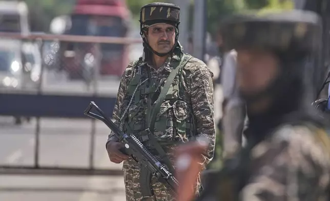 Indian paramilitary soldiers stand guard at a temporary checkpoint in Srinagar, Indian controlled Kashmir, Wednesday, April 30, 2025. (AP Photo/Dar Yasin)