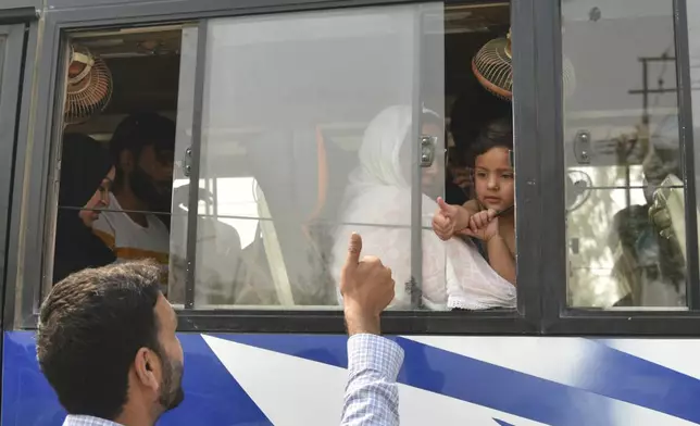 An Indian relative gives thumbs up to a Pakistani family as they leave in a bus at the Attari-Wagah border between India and Pakistan, near Amritsar, India, following New Delhi’s decision to order almost all Pakistani citizens to leave the country after last week’s deadly attack in Indian-controlled Kashmir, Wednesday, April 30, 2025. (AP Photo/Prabhjot Gill)