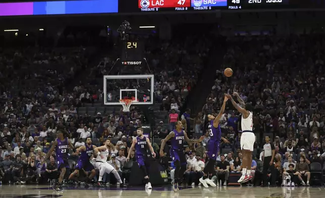 Los Angeles Clippers forward Kawhi Leonard (2) shoots at the buzzer against the Sacramento Kings during the first half of an NBA basketball game Friday, April 11, 2025, in Sacramento, Calif. (AP Photo/Scott Marshall)
