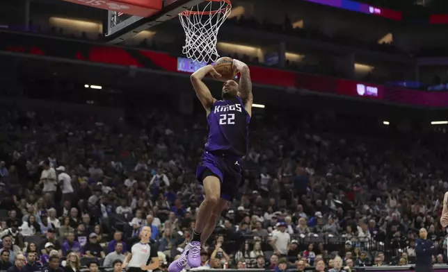 Sacramento Kings guard Devin Carter dunks against the Los Angeles Clippers during the first half of an NBA basketball game Friday, April 11, 2025, in Sacramento, Calif. (AP Photo/Scott Marshall)