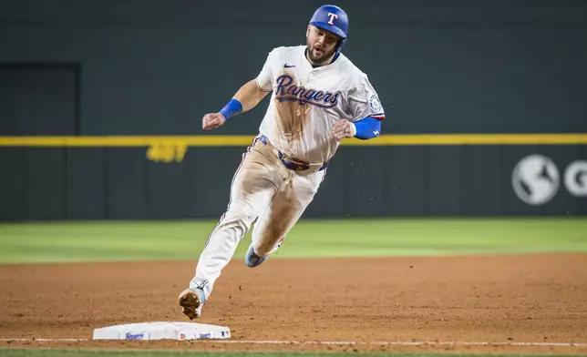 Texas Rangers' Jake Burger runs the bases against the Athletics during the sixth inning of a baseball game Tuesday, April 29, 2025, in Arlington, Texas. (AP Photo/Jessica Tobias)
