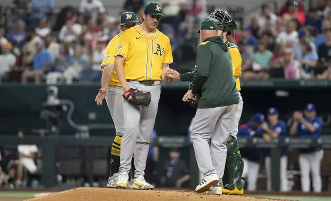 Athletics' Jacob Lopez is pulled during the third inning of a baseball game against the Texas Rangers, Tuesday, April 29, 2025, in Arlington, Texas. (AP Photo/Jessica Tobias)