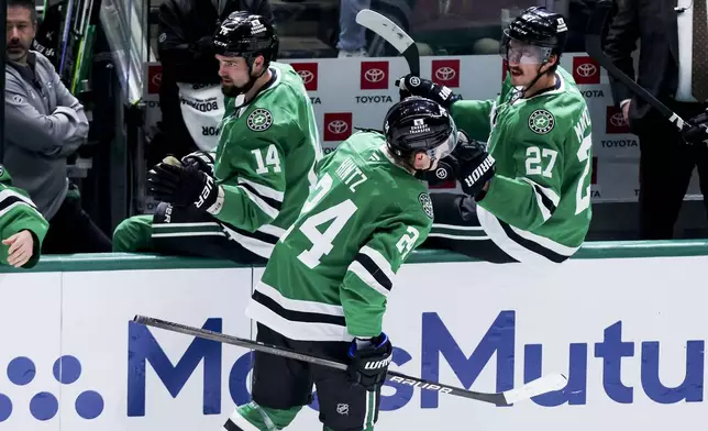 Dallas Stars center Roope Hintz (24) celebrates after scoring with Jamie Benn (14) and Mason Marchment (27) during a first-round NHL hockey playoff game against the Colorado Avalanche in Dallas, Saturday, April 19, 2025. (AP Photo/Gareth Patterson)
