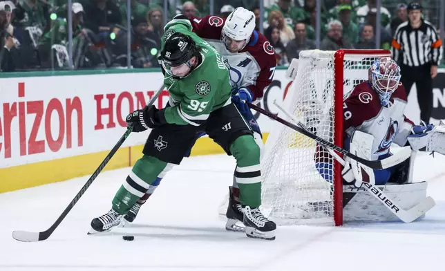 Dallas Stars center Matt Duchene (95) looks to shoot around Colorado Avalanche defenseman Devon Toews (7) during a first-round NHL hockey playoff game in Dallas, Saturday, April 19, 2025. (AP Photo/Gareth Patterson)
