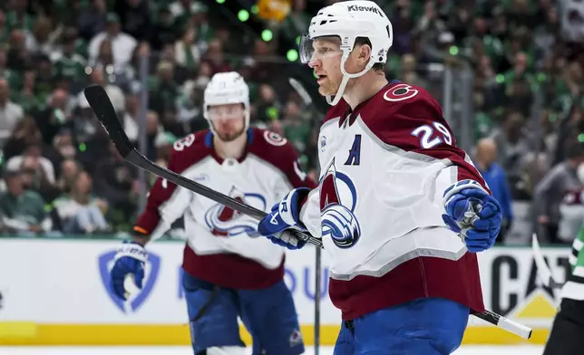 Colorado Avalanche center Nathan MacKinnon (29) celebrates after scoring a power-play goal during a first-round NHL hockey playoff game against the Dallas Stars in Dallas, Saturday, April 19, 2025. (AP Photo/Gareth Patterson)