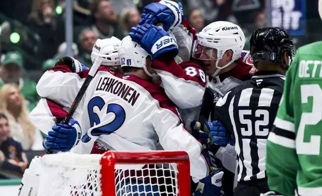 Colorado Avalanche left wing Artturi Lehkonen (62) celebrates with teammates after scoring against the Dallas Stars in the second period during a first-round NHL hockey playoff game in Dallas, Saturday, April 19, 2025. (AP Photo/Gareth Patterson)