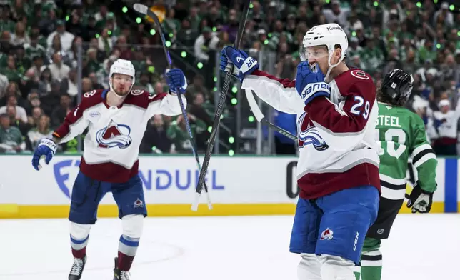 Colorado Avalanche center Nathan MacKinnon (29) celebrates after scoring a power-play goal during a first-round NHL hockey playoff game against the Dallas Stars in Dallas, Saturday, April 19, 2025. (AP Photo/Gareth Patterson)